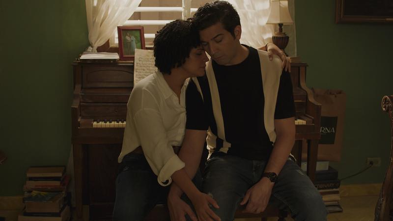 Brother and sister share a quiet moment at the piano